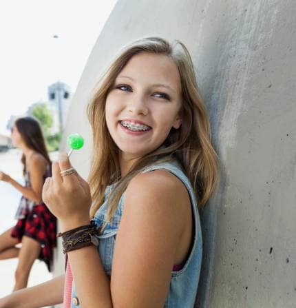 girl smiling with lollipop
