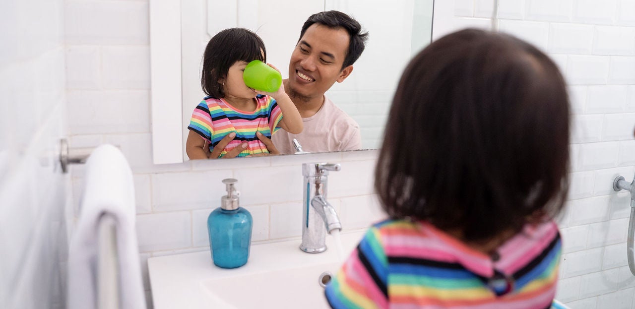 little girl gargle after brush her teeth