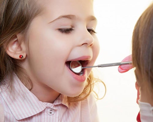 child opening mouth to dentist